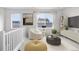 Bright loft space with a plush chair, side table, and views of the neighborhood at 8028 Williams Fork Ave, Littleton, CO 80125