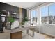 Home office featuring natural light, a modern desk, shelving, and views of the neighborhood at 8028 Williams Fork Ave, Littleton, CO 80125