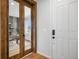 View of a home office through french doors, featuring natural light and a modern desk at 8028 Williams Fork Ave, Littleton, CO 80125