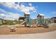 Exterior view of the community playground with slides, climbing structures, and seating at 8028 Williams Fork Ave, Littleton, CO 80125