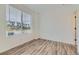 Bedroom featuring wood-look floors and a large window at 1759 Peak Loop, Broomfield, CO 80023