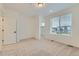 Bright bedroom featuring plush carpeting, walk-in closet, and large window at 1759 Peak Loop, Broomfield, CO 80023