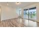 Bright living room with wood floors and sliding glass doors to outdoor deck at 1759 Peak Loop, Broomfield, CO 80023