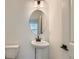 Chic powder room with pedestal sink, oval mirror, and modern fixtures at 1759 Peak Loop, Broomfield, CO 80023