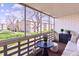 Screened balcony with outdoor seating, providing a tranquil space with views of the lawn and surrounding community at 745 S Alton Way # 9B, Denver, CO 80247
