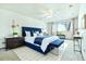 Bright bedroom with a large window, blue bed, and a cozy bench at 745 S Alton Way # 9B, Denver, CO 80247