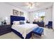Stylish bedroom with a plush blue bed, dresser, and bright natural light at 745 S Alton Way # 9B, Denver, CO 80247