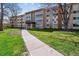 Apartment building with a well-manicured lawn and walkway, providing a welcoming entrance to residents and visitors at 745 S Alton Way # 9B, Denver, CO 80247