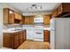 Traditional kitchen featuring wood cabinets, white appliances, and neutral countertops at 745 S Alton Way # 9B, Denver, CO 80247