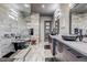Contemporary bathroom featuring marble walls, dual vanities, and a glass-enclosed shower at 10106 W 69Th Pl, Arvada, CO 80004