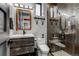 Stylish bathroom features a modern vanity, toilet, and walk-in shower with decorative tiles, creating a sophisticated space at 10106 W 69Th Pl, Arvada, CO 80004