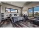Serene bedroom with scenic views, hardwood floors, and a cozy sitting area at 10106 W 69Th Pl, Arvada, CO 80004