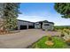 Modern home featuring a long driveway, minimalist landscaping, and a mountain view in the background at 10106 W 69Th Pl, Arvada, CO 80004