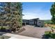 Modern home exterior with a large driveway, landscaping, and a stylish entrance at 10106 W 69Th Pl, Arvada, CO 80004