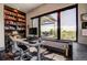 Bright home office with built-in shelving, a large window, and a view of the outdoors at 10106 W 69Th Pl, Arvada, CO 80004