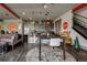 Open-concept living room with a dining area, sofa, decorative rugs, and unique road sign decor at 10106 W 69Th Pl, Arvada, CO 80004