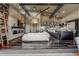 Open-concept living room featuring high ceilings, hardwood floors, modern fireplace, and seamless flow to kitchen at 10106 W 69Th Pl, Arvada, CO 80004