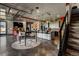 Bright and airy living space with a large kitchen island, dining area, stairs, and outside access at 10106 W 69Th Pl, Arvada, CO 80004