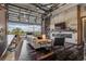 Open-concept living room featuring a fireplace, custom bookshelves, and an expansive glass retractable wall at 10106 W 69Th Pl, Arvada, CO 80004