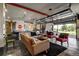 Spacious living area with road sign decor, an open kitchen area, and a retractable glass wall at 10106 W 69Th Pl, Arvada, CO 80004