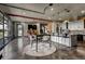A spacious living room features an open floor plan and an industrial-style kitchen and dining area at 10106 W 69Th Pl, Arvada, CO 80004