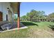 Outdoor barn patio with a relaxing bench, providing a serene view of the lush lawn at 11510 Lewistown St, Commerce City, CO 80022