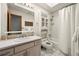 Bright bathroom with white tile, built-in shelves, and shower-tub combination at 11510 Lewistown St, Commerce City, CO 80022
