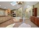 Bathroom with wood cabinets, a fireplace, a soaking tub, and skylights at 11510 Lewistown St, Commerce City, CO 80022