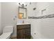 Bathroom features a vanity with dark wood cabinets and drawers with a walk-in tiled shower at 11510 Lewistown St, Commerce City, CO 80022
