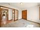 Bedroom with wood trim and doors, with a view of another area, and neutral carpet at 11510 Lewistown St, Commerce City, CO 80022
