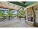 Spacious deck area with stone fireplace and views of pool and yard at 11510 Lewistown St, Commerce City, CO 80022