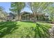 Beautiful green lawn leading up to the home with a covered porch and stone accents at 11510 Lewistown St, Commerce City, CO 80022