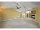 Spacious living room with a vaulted ceiling, fireplace, neutral carpet, and lots of natural light at 11510 Lewistown St, Commerce City, CO 80022