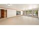 Large living room with hardwood trim, multiple windows with a view to the backyard and staircase at 11510 Lewistown St, Commerce City, CO 80022