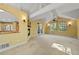 Spacious living room with a fireplace, neutral carpet, many windows, and a partial view of the kitchen at 11510 Lewistown St, Commerce City, CO 80022