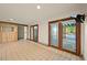 Large living room offering access to the backyard pool, tile floors, and natural lighting at 11510 Lewistown St, Commerce City, CO 80022