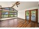 Cozy living room with wood floors, fan, and large windows overlooking the landscape at 11510 Lewistown St, Commerce City, CO 80022