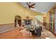 Inviting living room featuring a stone fireplace, hardwood floors, and comfortable seating at 11510 Lewistown St, Commerce City, CO 80022