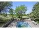 Backyard pool area surrounded by mature trees and a fenced yard at 11510 Lewistown St, Commerce City, CO 80022