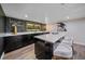 Chic home bar featuring sleek countertops, stylish bar stools, and elegant display shelving at 805 Elm St, Denver, CO 80220