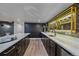 Modern home bar featuring a white countertop, stylish cabinetry, and a built-in display at 805 Elm St, Denver, CO 80220