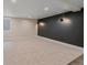 Spacious basement featuring neutral carpet, modern sconces, and ample room for customization at 805 Elm St, Denver, CO 80220