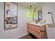 Stylish bathroom with textured wallpaper, wood vanity, and gold-framed mirror at 805 Elm St, Denver, CO 80220