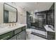 Sleek bathroom featuring black marble shower, and green vanity with modern fixtures at 805 Elm St, Denver, CO 80220
