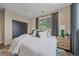 Comfortable bedroom featuring a bed, black closet, and windows dressed with elegant gray curtains at 805 Elm St, Denver, CO 80220