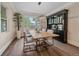 Elegant dining room featuring a modern light fixture, and a large window, adjacent to a spacious dining table and chairs at 805 Elm St, Denver, CO 80220