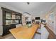 Open-concept space connects dining and living areas, boasting a stylish light fixture and a view of the adjacent living room at 805 Elm St, Denver, CO 80220