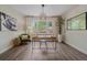 Bright home office featuring modern decor, wood floors, large window, and an accent chair at 805 Elm St, Denver, CO 80220