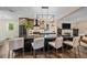 Stylish kitchen island with seating, showcasing the pendant lighting, and modern appliances, with an open view to the Gathering room at 805 Elm St, Denver, CO 80220