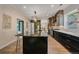 Beautiful kitchen featuring a large island with marble countertops, modern appliances, and stylish pendant lighting at 805 Elm St, Denver, CO 80220
